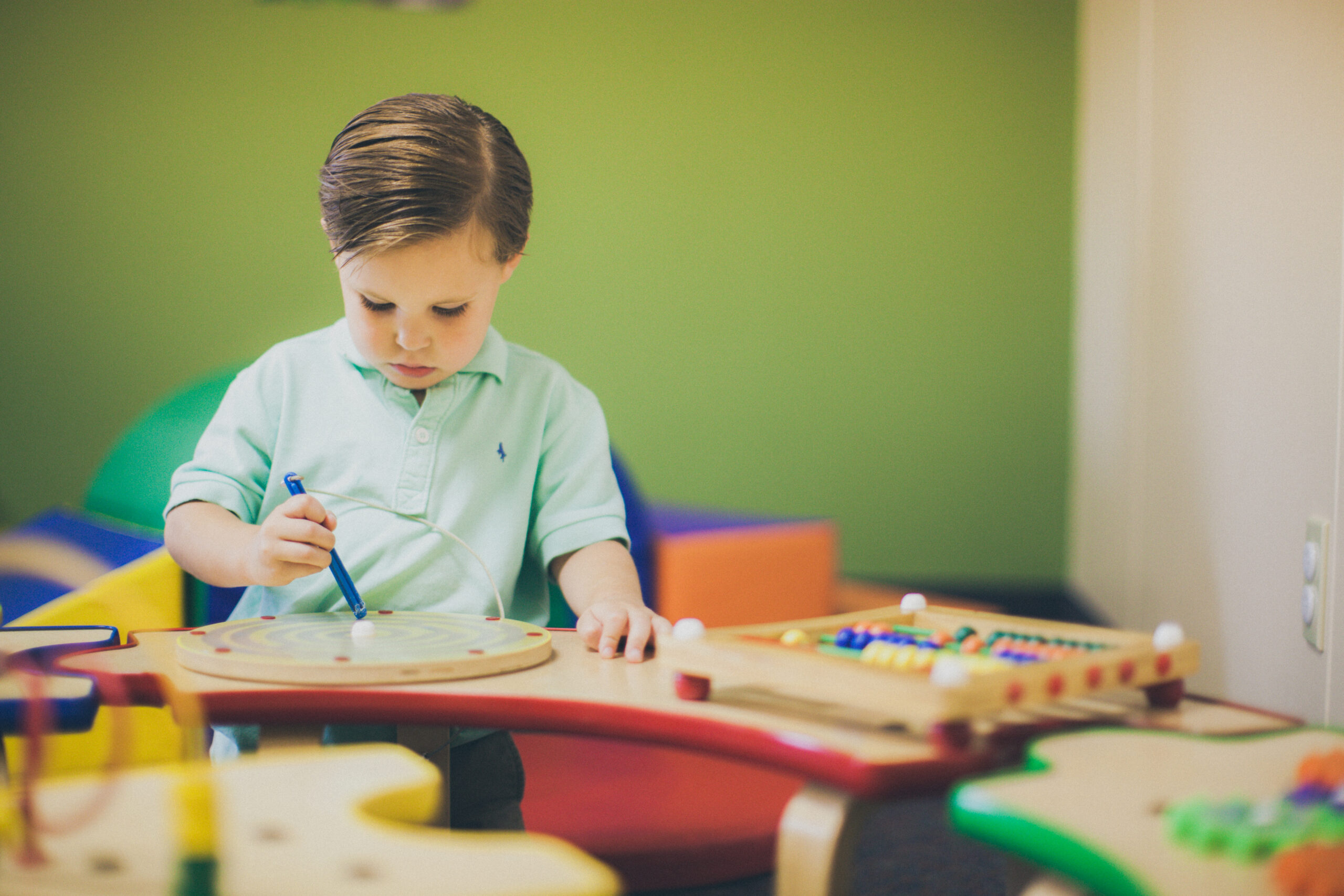 boy_toddler_playing_with_toys_in_a_church_nursery-5616×3744